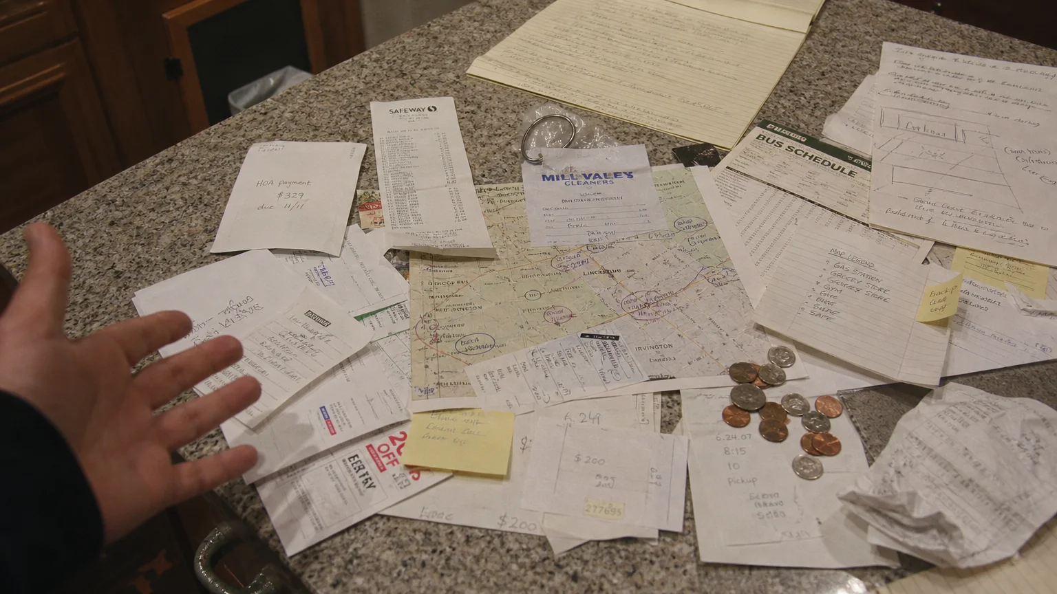 A high-angle photo of a kitchen counter cluttered with unnecessary receipts and maps, representing overcompensation in a lie.